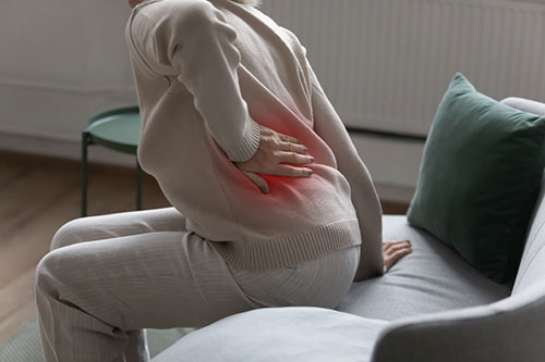 Lower back pain symptoms depicted for injury claims In Buffalo, NY. | Pigott Law Group